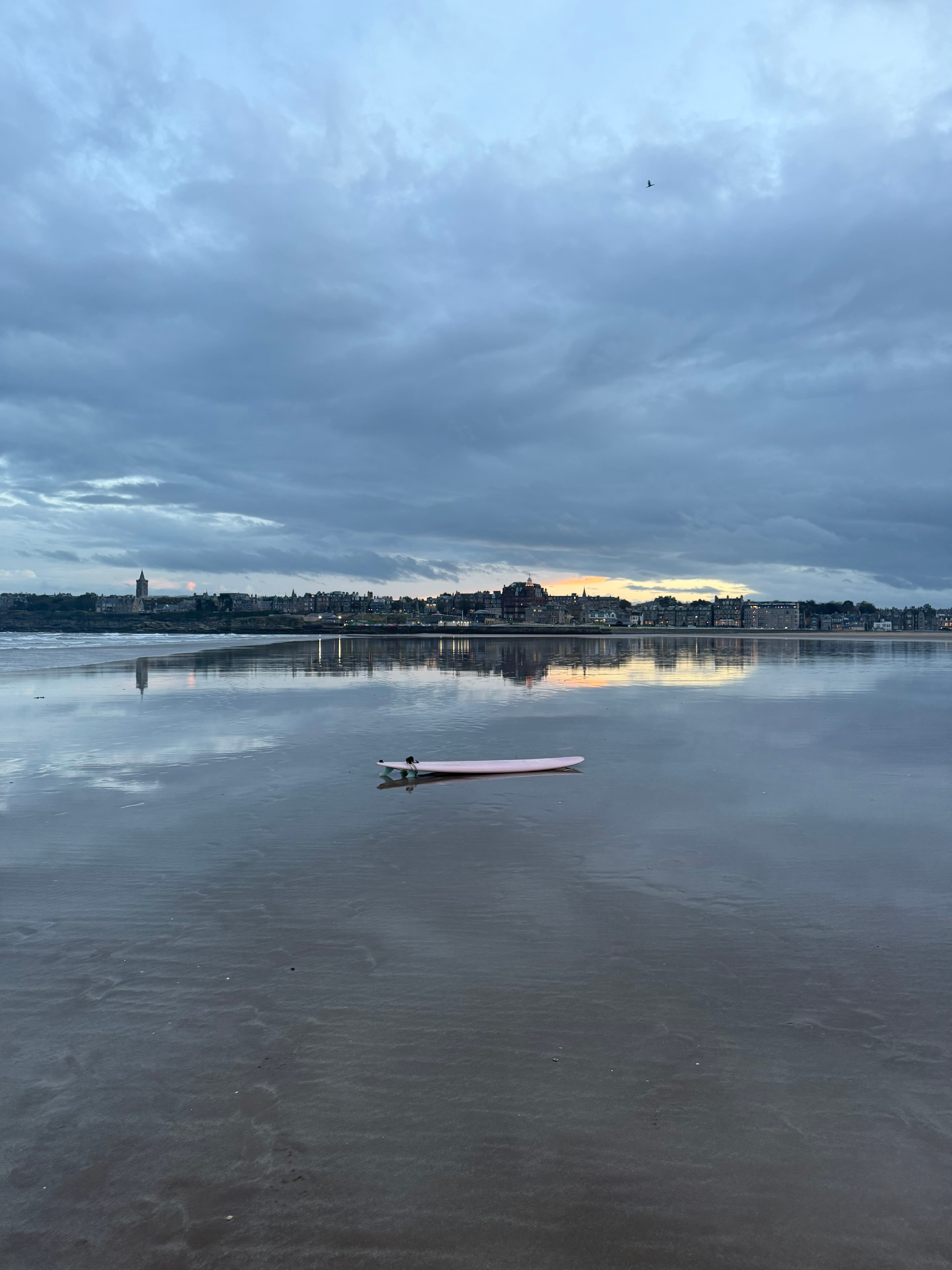 A surfboard on the beach at the club's local surf break